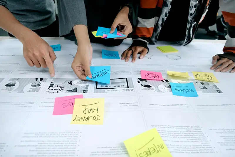 digital-strategy-planning Marketing team working on a strategy with post-it notes